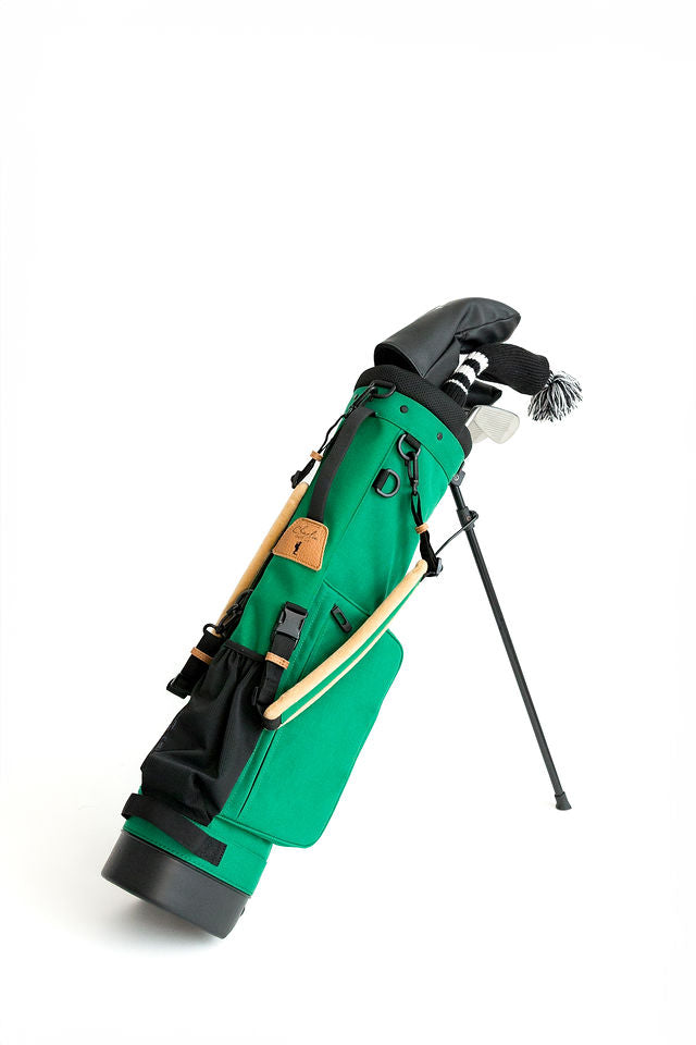 green junior golf bag with junior golf clubs