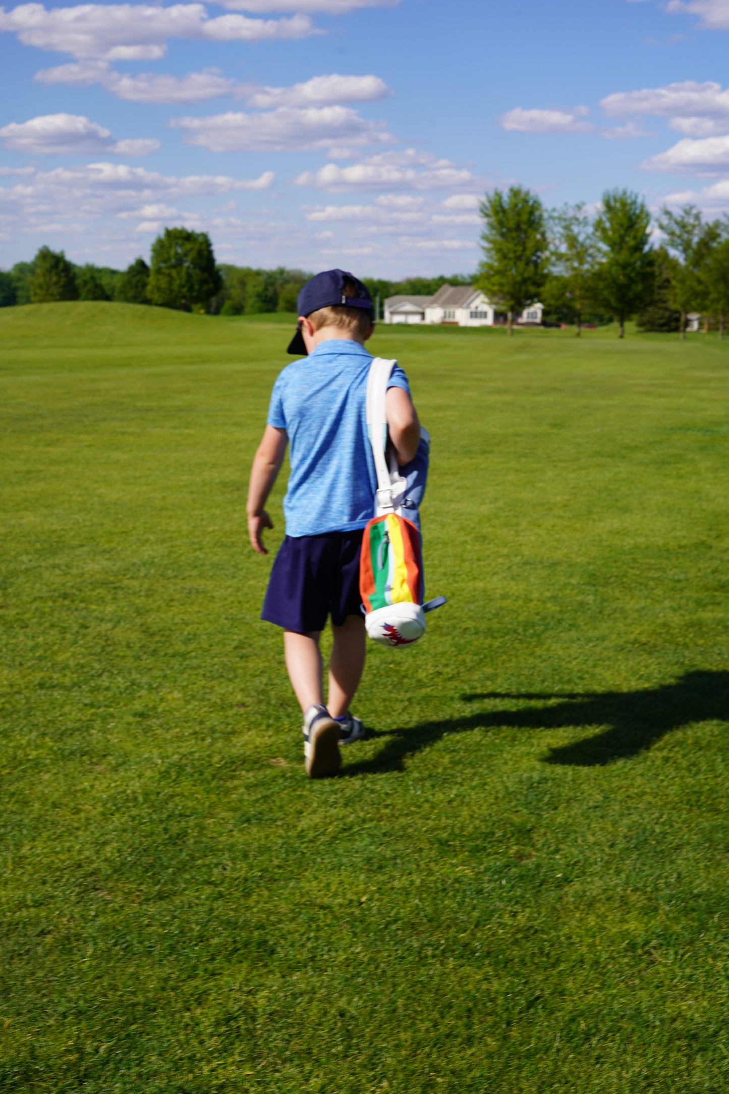 kid walking with Sugarloaf Social Club toddler golf bag