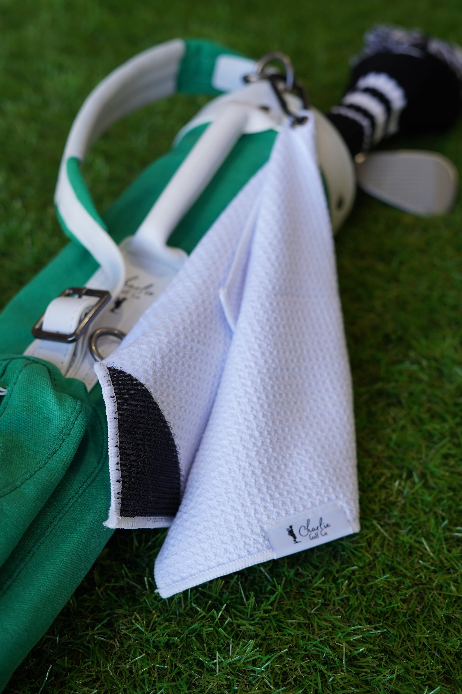green kids golf club set with white golf towel