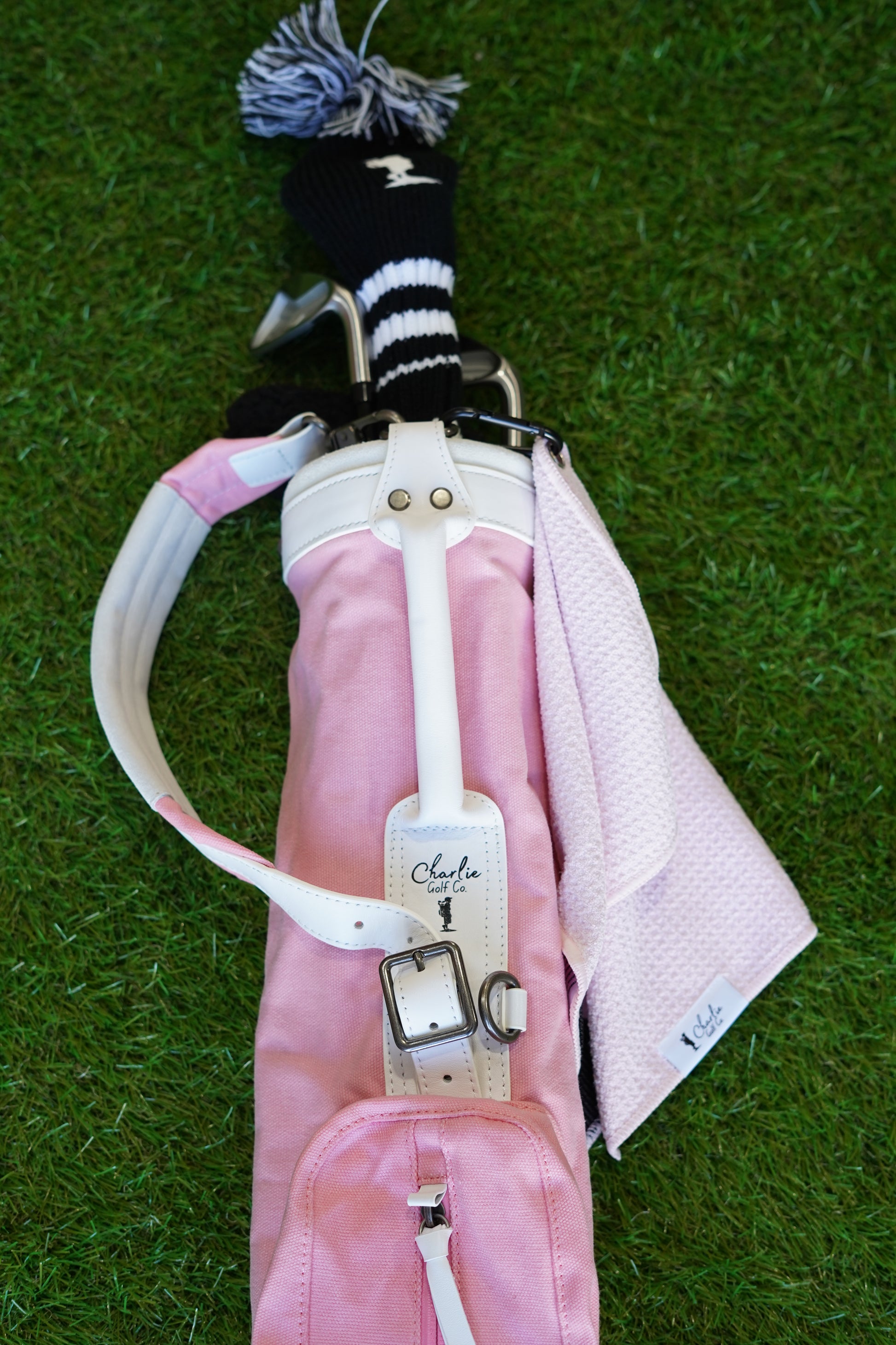 Pink kids golf bag with clubs and kids golf towel