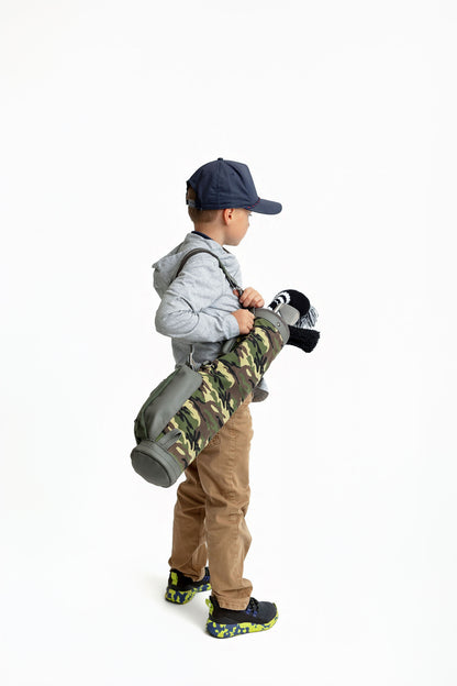 kid with green camo golf bag and kids golf club set