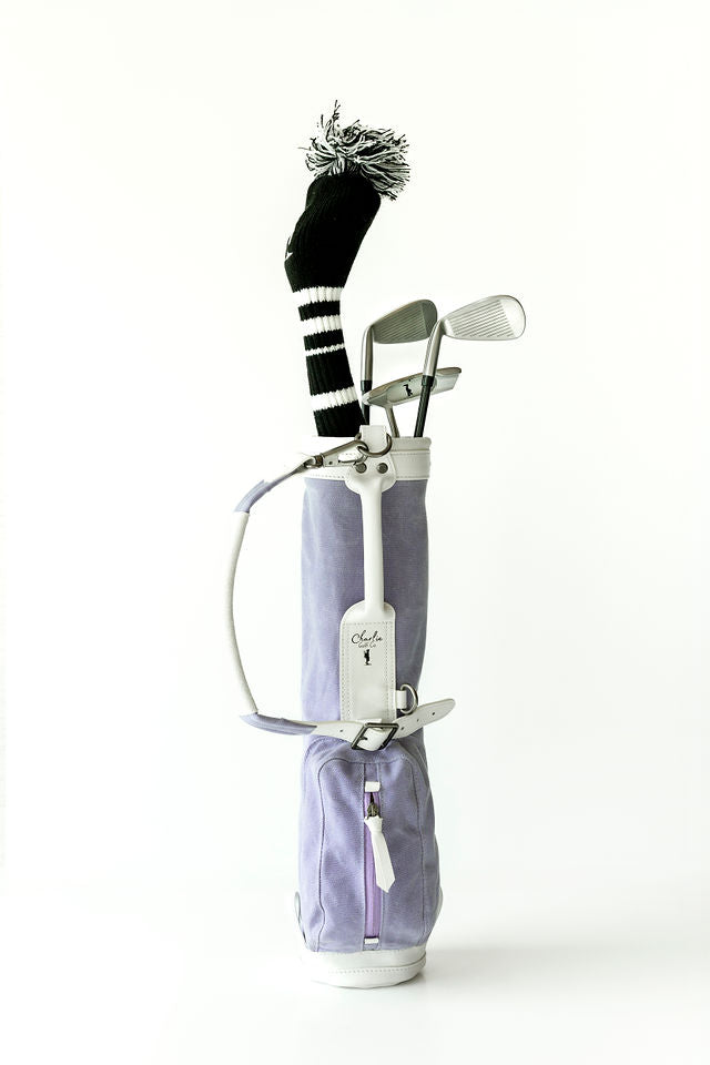 kids golf clubs in a light purple kids golf bag