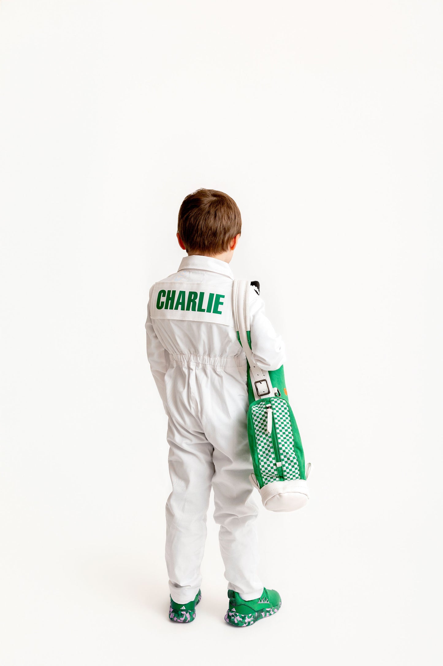 charlie golf kid holding kid golf bag with kids golf clubs