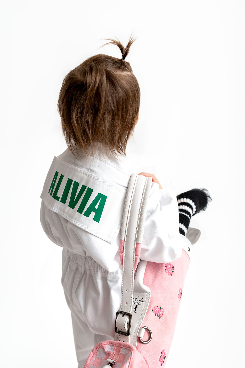 girl holding a kids golf bag 