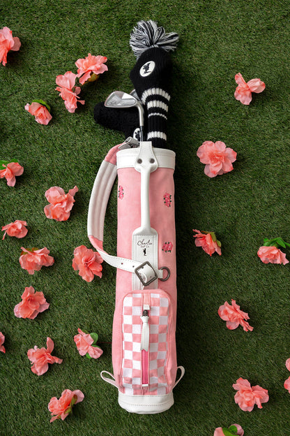 youth golf clubs inside a pink toddler golf bag with flowers