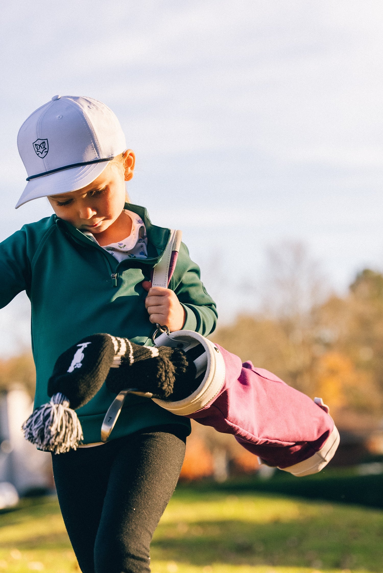 Kids golf bag being carried by a toddler golfer